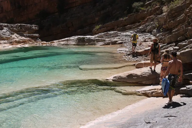 Turquoise rock pools between pale boulders in Paradise Valley, Morocco